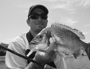 Kris Hickson with a nice bream caught casting pink grubs in the canals last October.